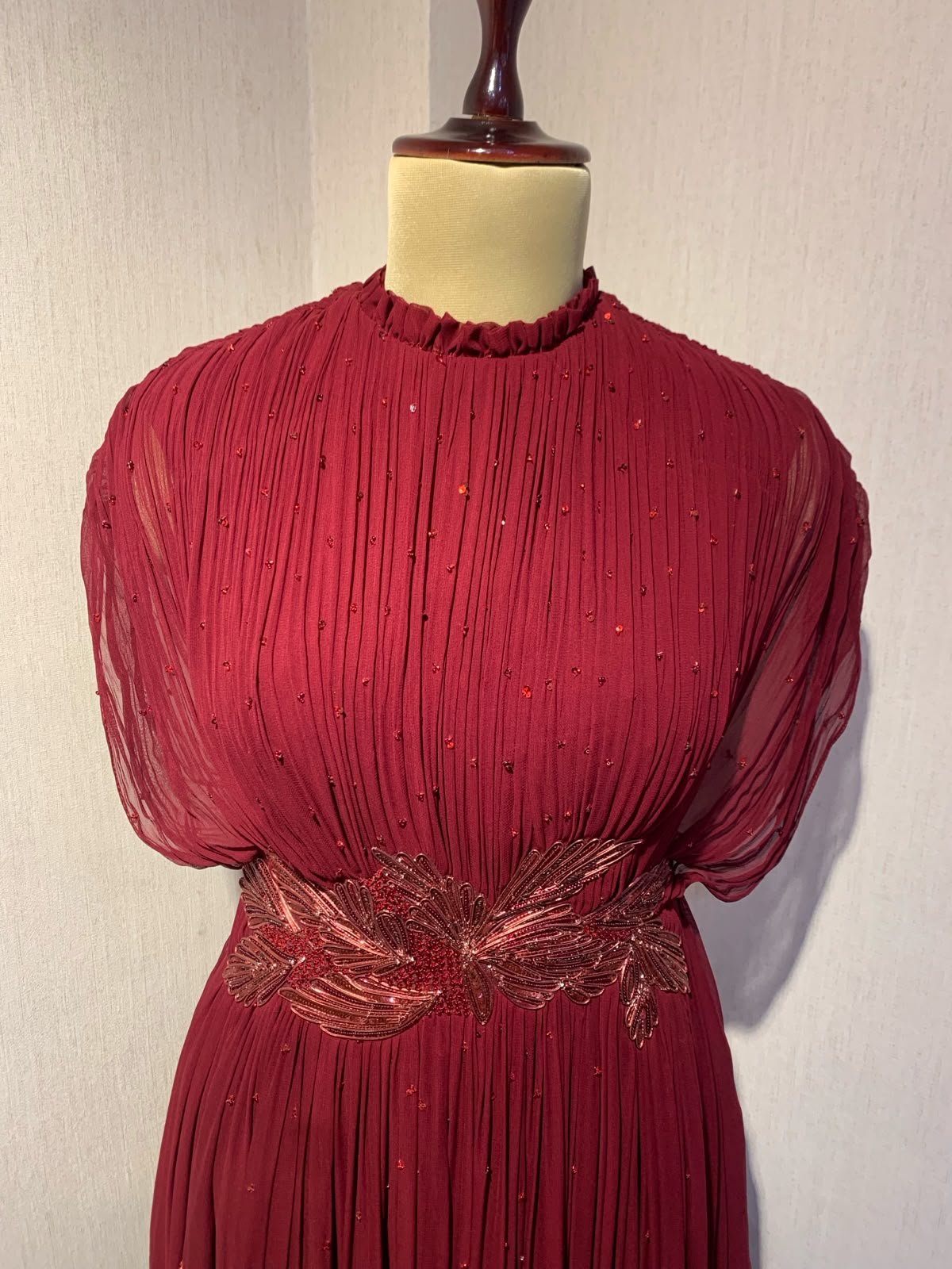 MAROON WIRE EMBELLISHED PLEATED GOWN WITH SHEER SLEEVES.