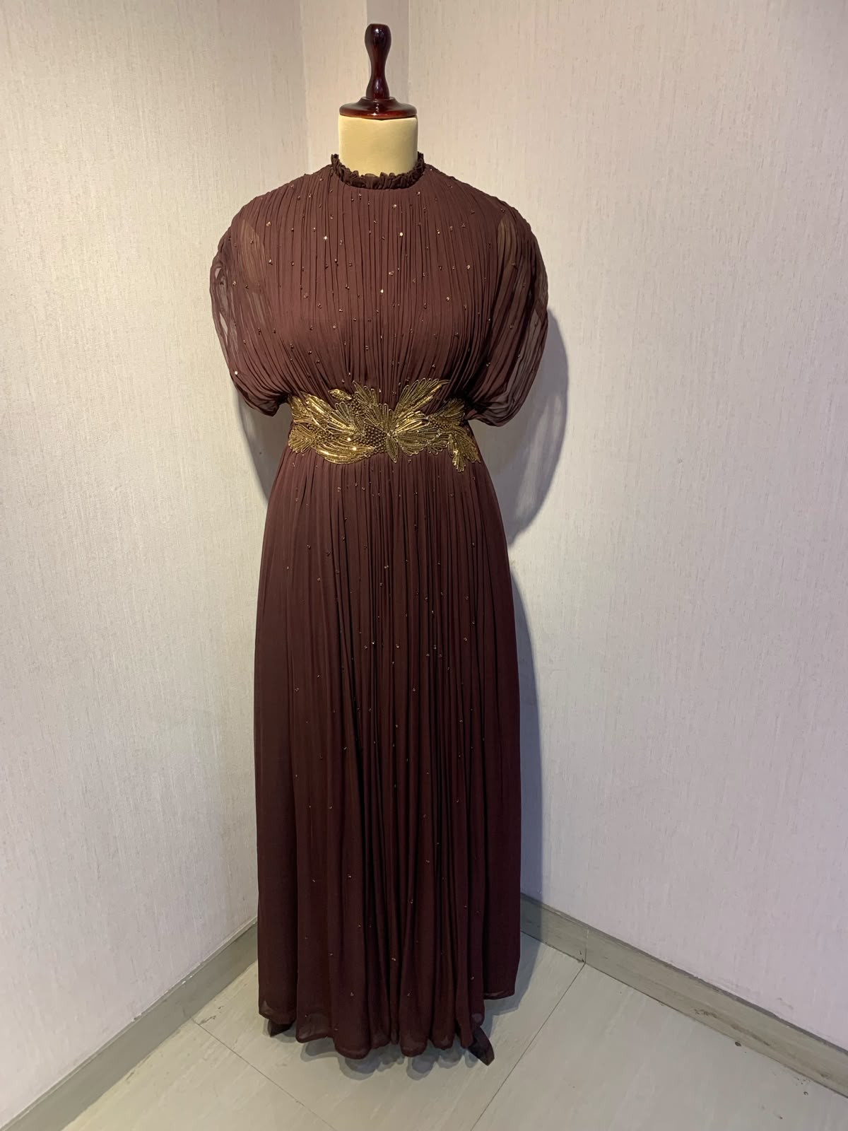 BROWN  WIRE EMBELLISHED PLEATED GOWN WITH SHEER SLEEVES.