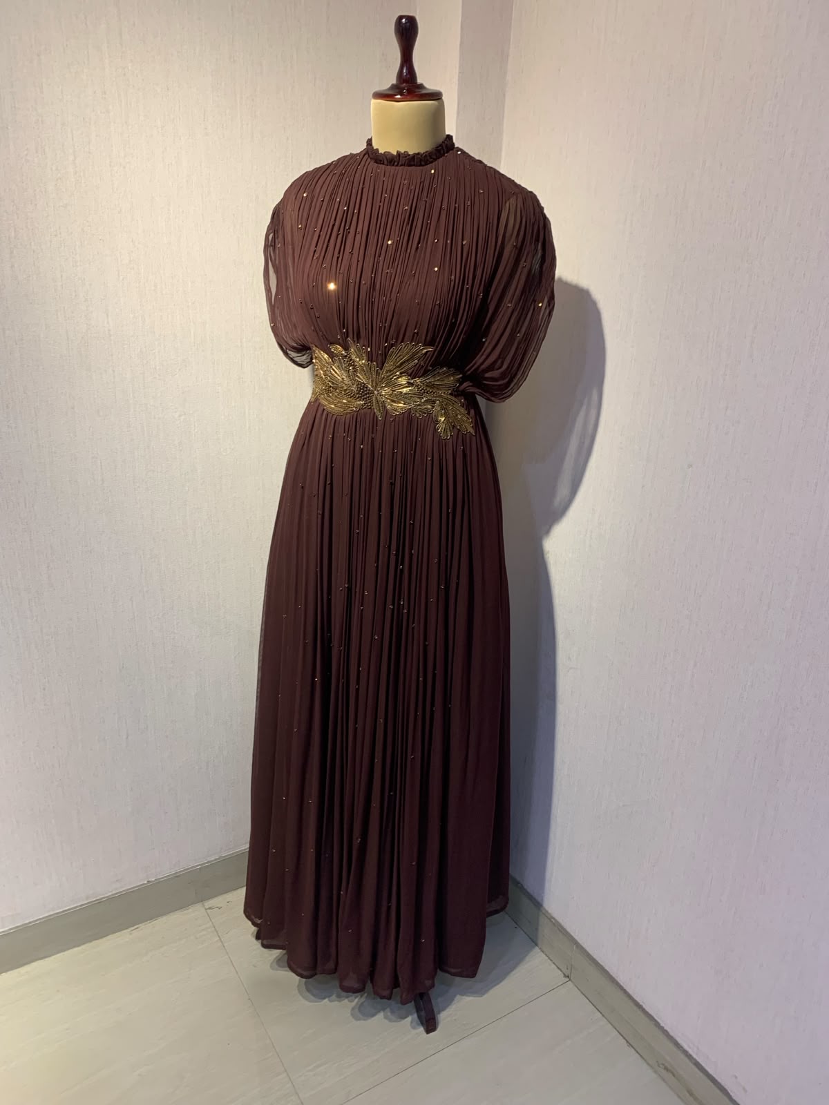 BROWN  WIRE EMBELLISHED PLEATED GOWN WITH SHEER SLEEVES.