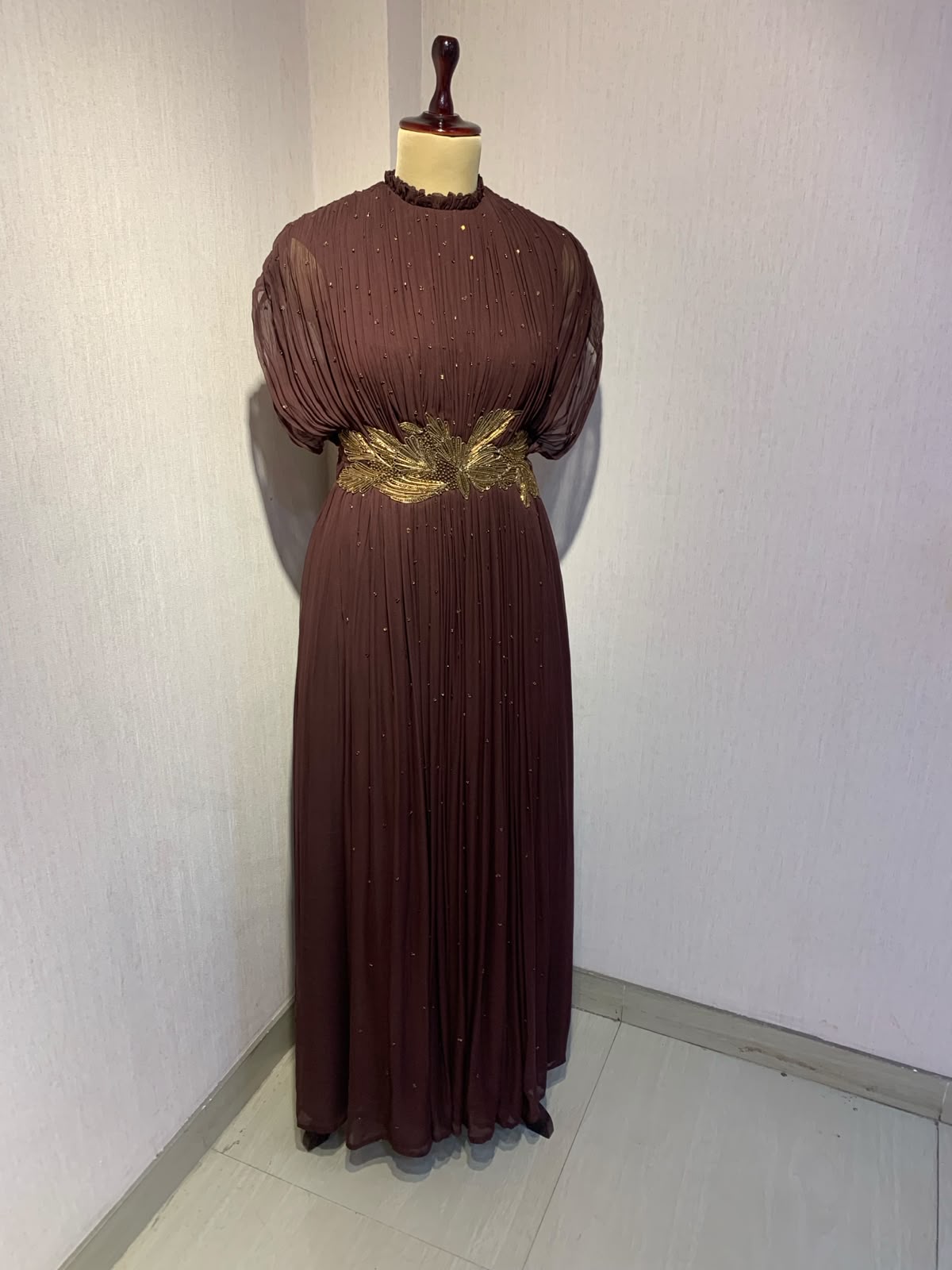BROWN  WIRE EMBELLISHED PLEATED GOWN WITH SHEER SLEEVES.