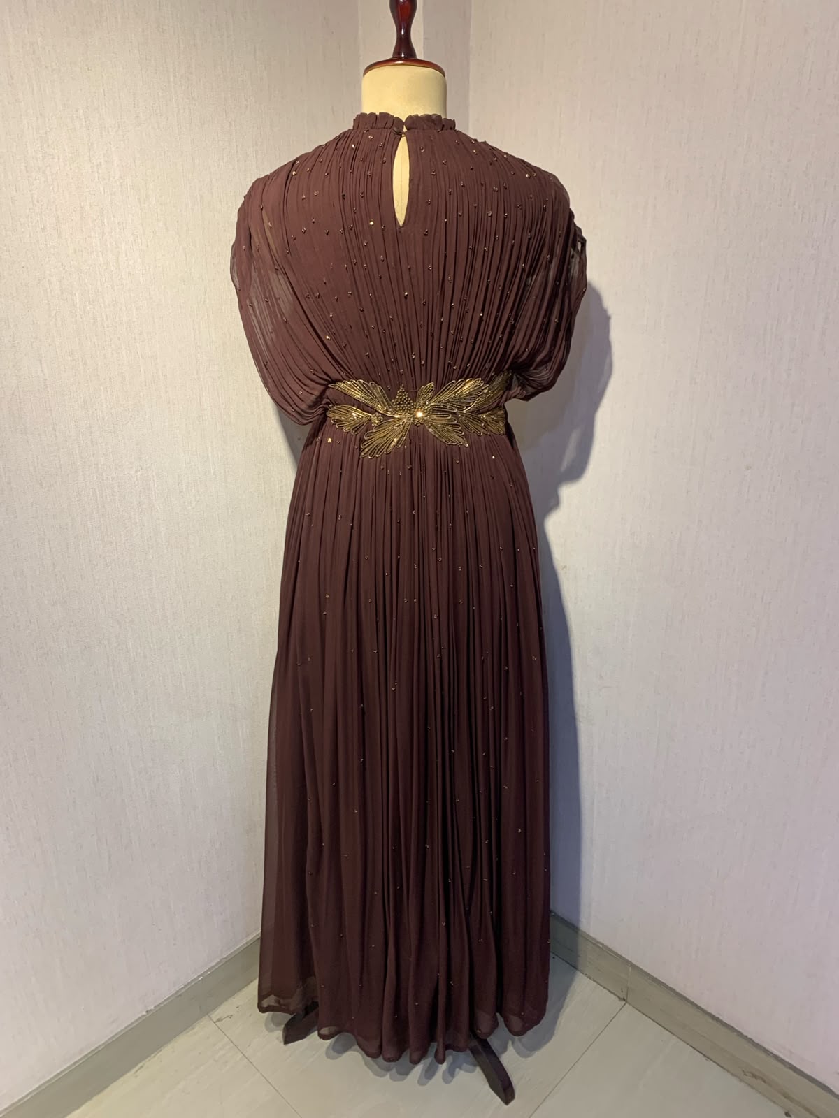 BROWN  WIRE EMBELLISHED PLEATED GOWN WITH SHEER SLEEVES.