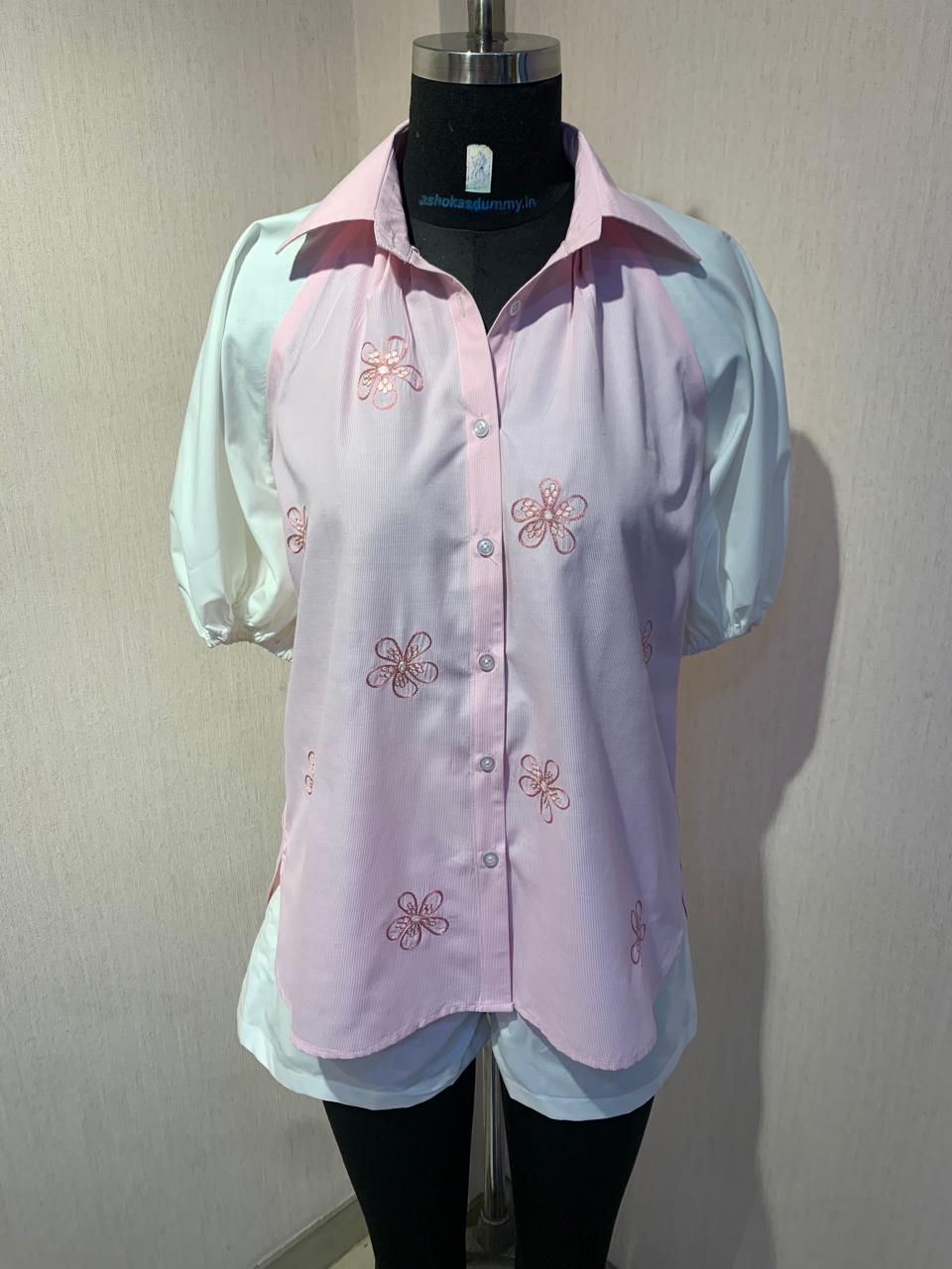 EMBROIDERED PINK SHIRT WITH WHITE SHORTS.