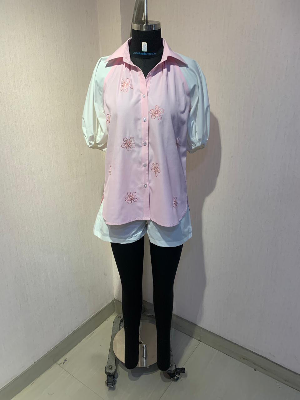 EMBROIDERED PINK SHIRT WITH WHITE SHORTS.