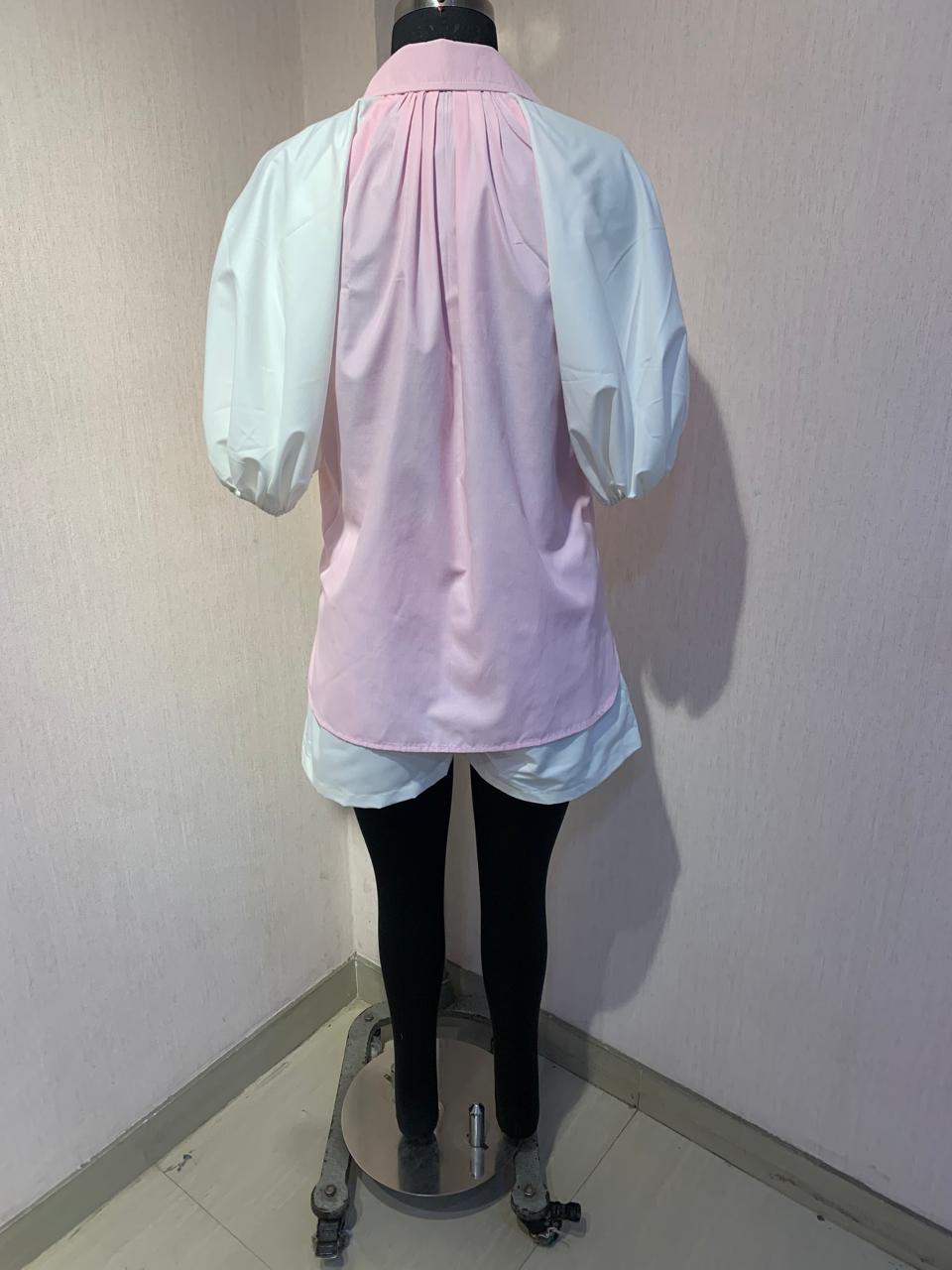 EMBROIDERED PINK SHIRT WITH WHITE SHORTS.