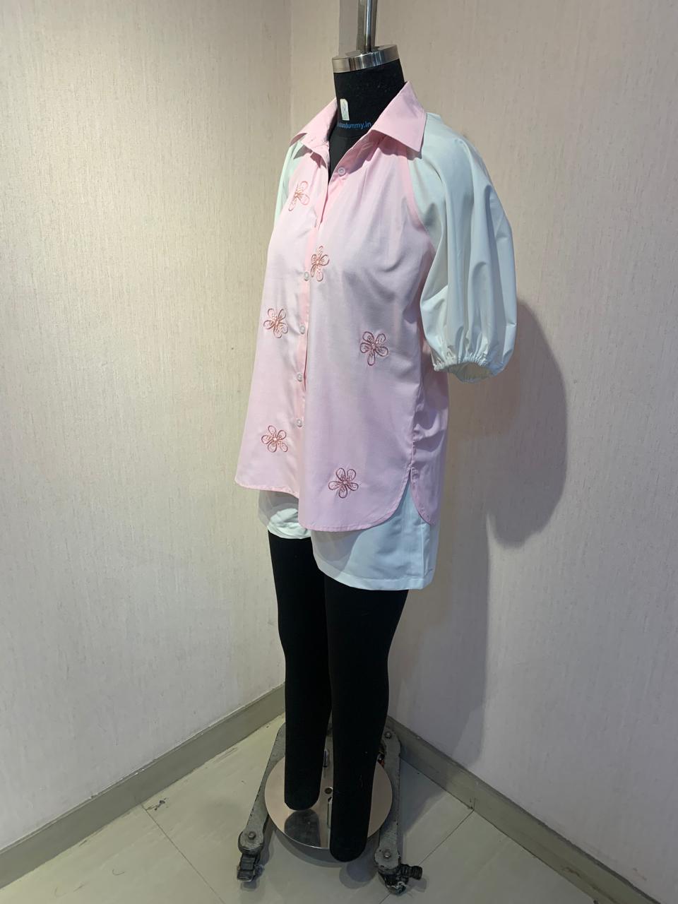 EMBROIDERED PINK SHIRT WITH WHITE SHORTS.