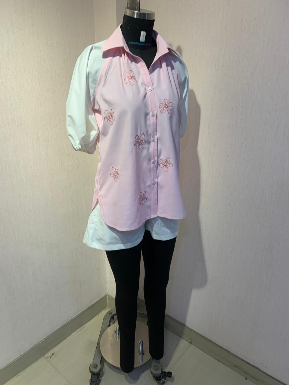 EMBROIDERED PINK SHIRT WITH WHITE SHORTS.