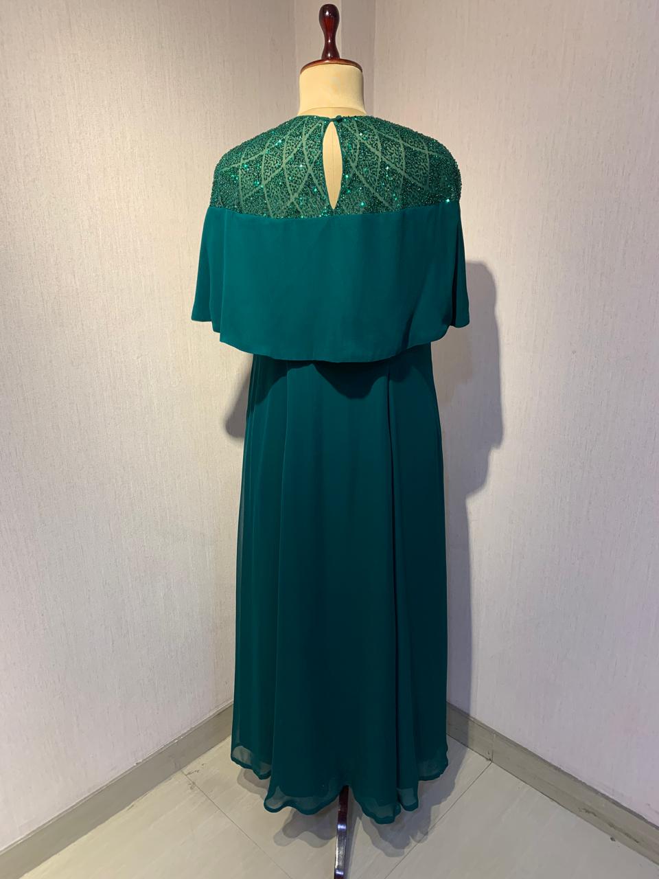 GREEN SEQUIN AND BEAD EMBELLISHED GOWN WITH SHEER NECKLINE.