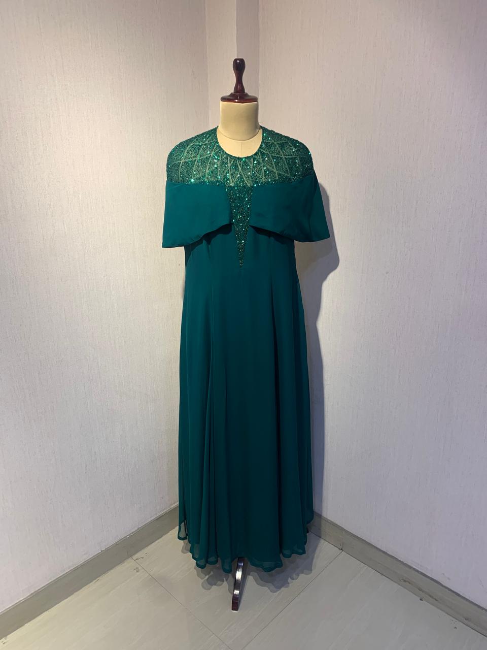 GREEN SEQUIN AND BEAD EMBELLISHED GOWN WITH SHEER NECKLINE.