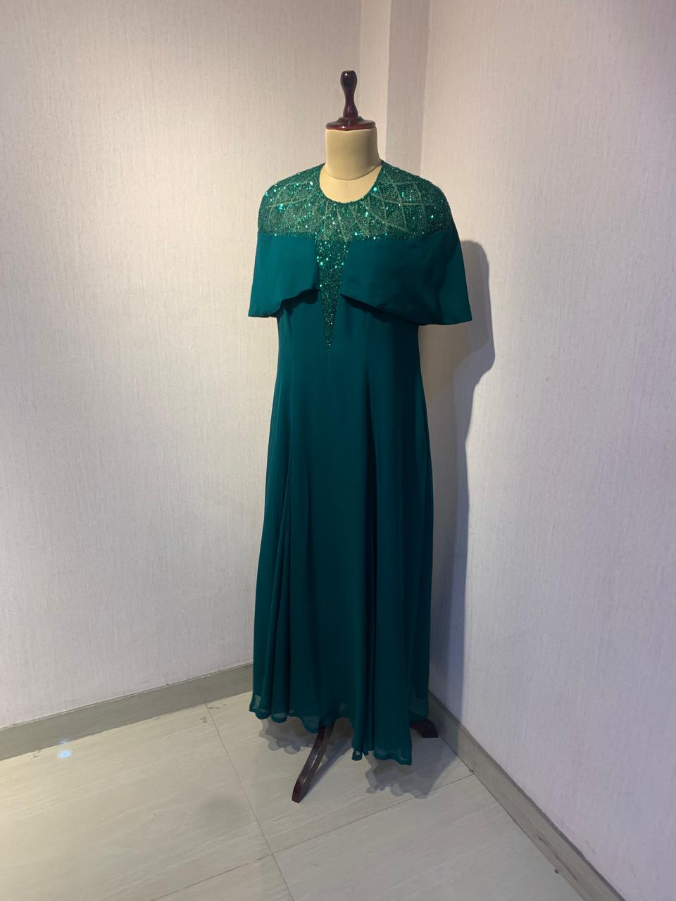 GREEN SEQUIN AND BEAD EMBELLISHED GOWN WITH SHEER NECKLINE.