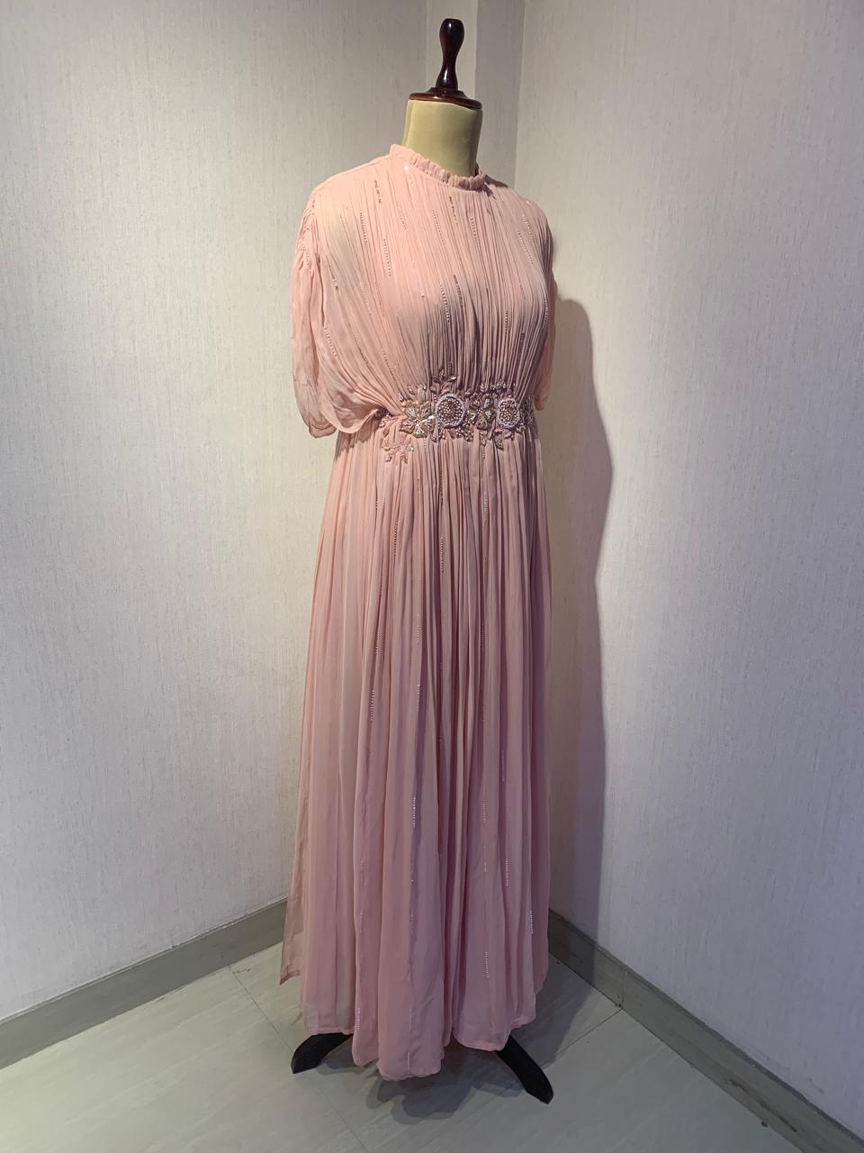 ELEGANT PINK PLEATED GOWN WITH EMBELLISHED WAIST.