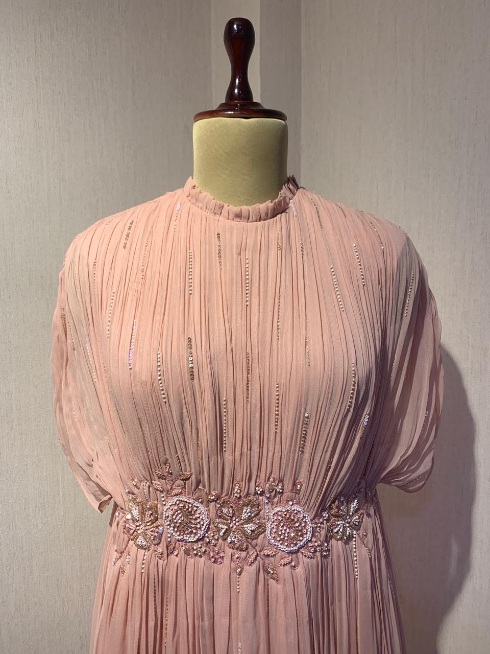 ELEGANT PINK PLEATED GOWN WITH EMBELLISHED WAIST.