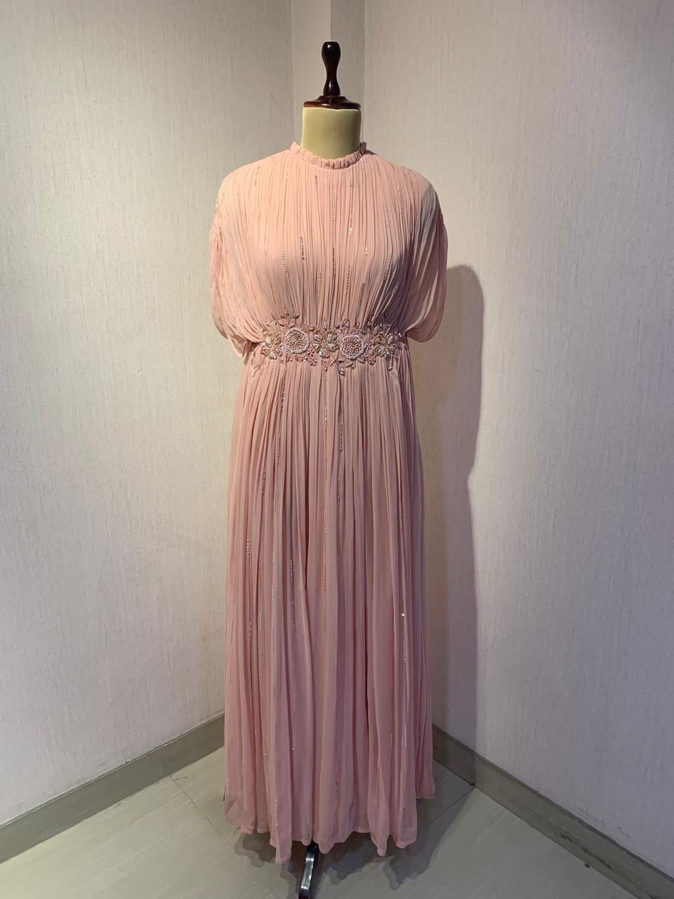 ELEGANT PINK PLEATED GOWN WITH EMBELLISHED WAIST.
