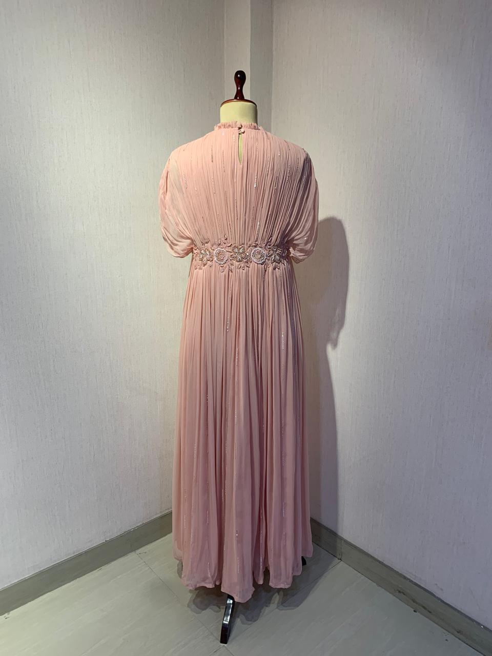 ELEGANT PINK PLEATED GOWN WITH EMBELLISHED WAIST.