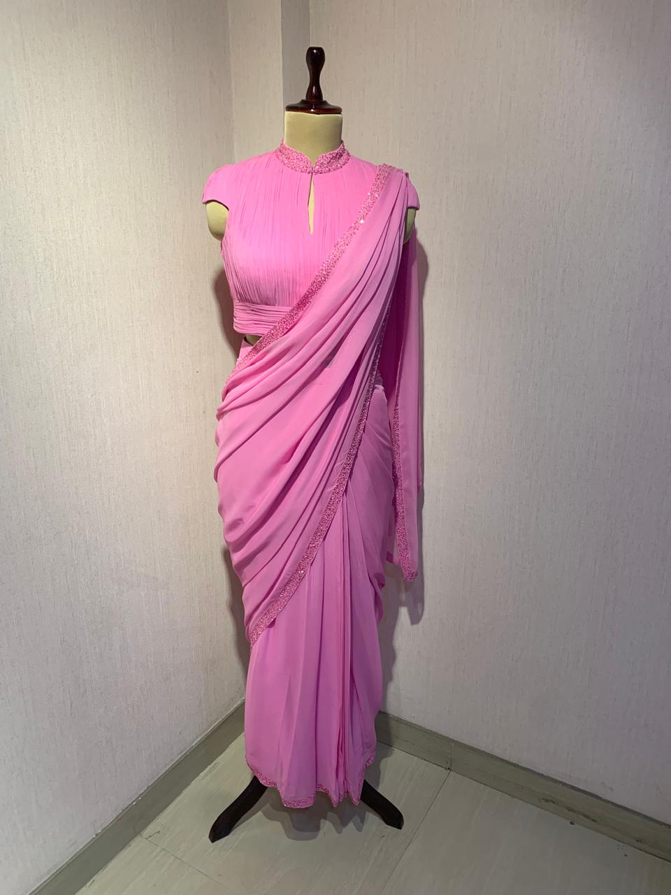 PINK GEORGETTE DRAPED SAREE WITH PLEATED HIGH NECK BLOUSE.
