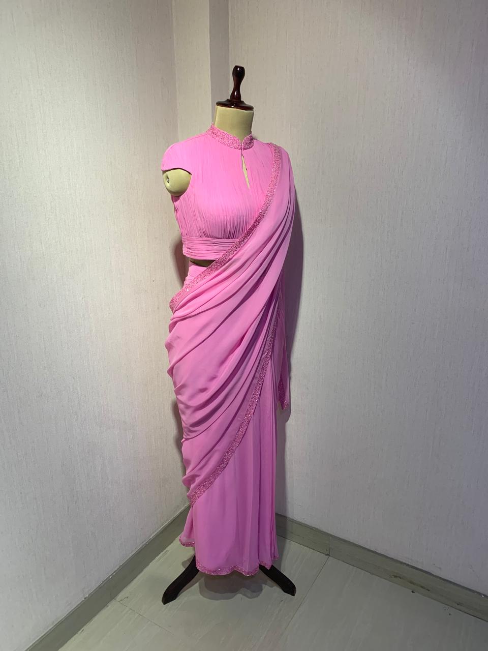 PINK GEORGETTE DRAPED SAREE WITH PLEATED HIGH NECK BLOUSE.