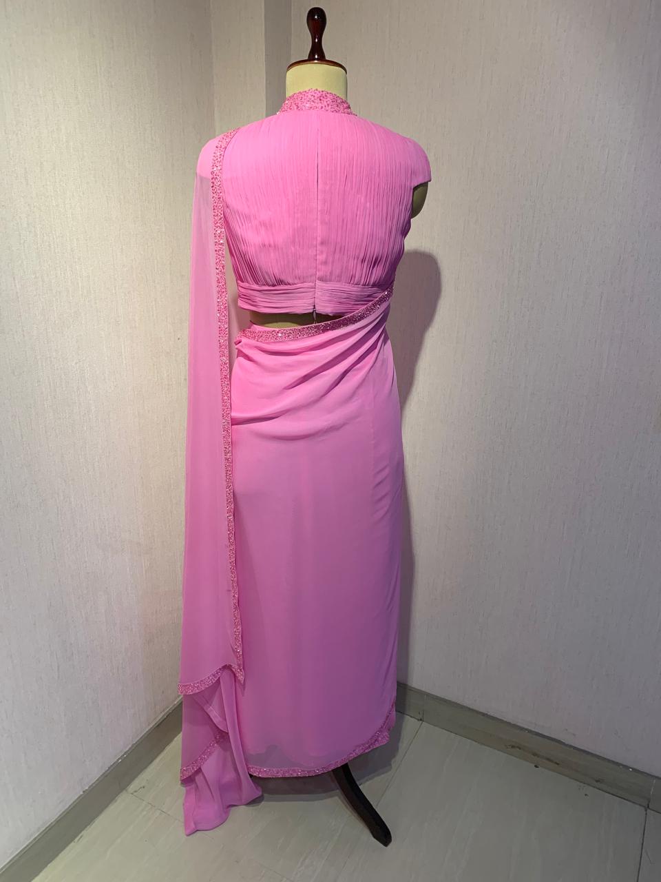 PINK GEORGETTE DRAPED SAREE WITH PLEATED HIGH NECK BLOUSE.