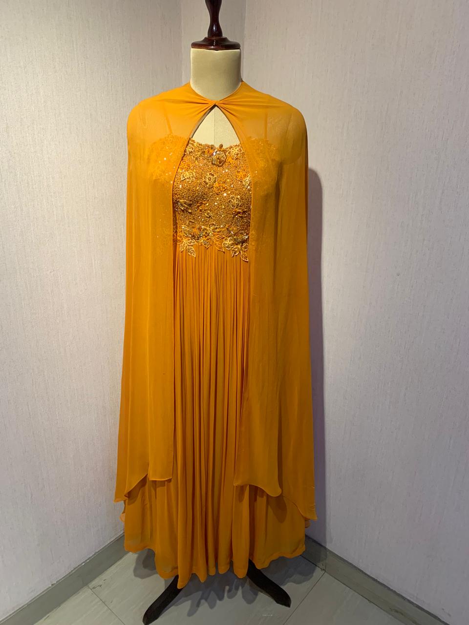 RUST EMBELLISHED CAPE STYLE PLEATED GOWN.