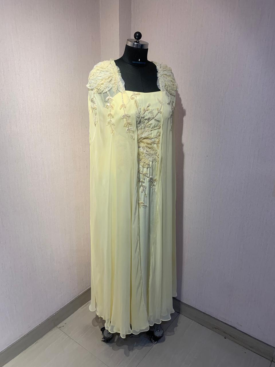 FLORAL EMBROIDERED CAPE GOWN.