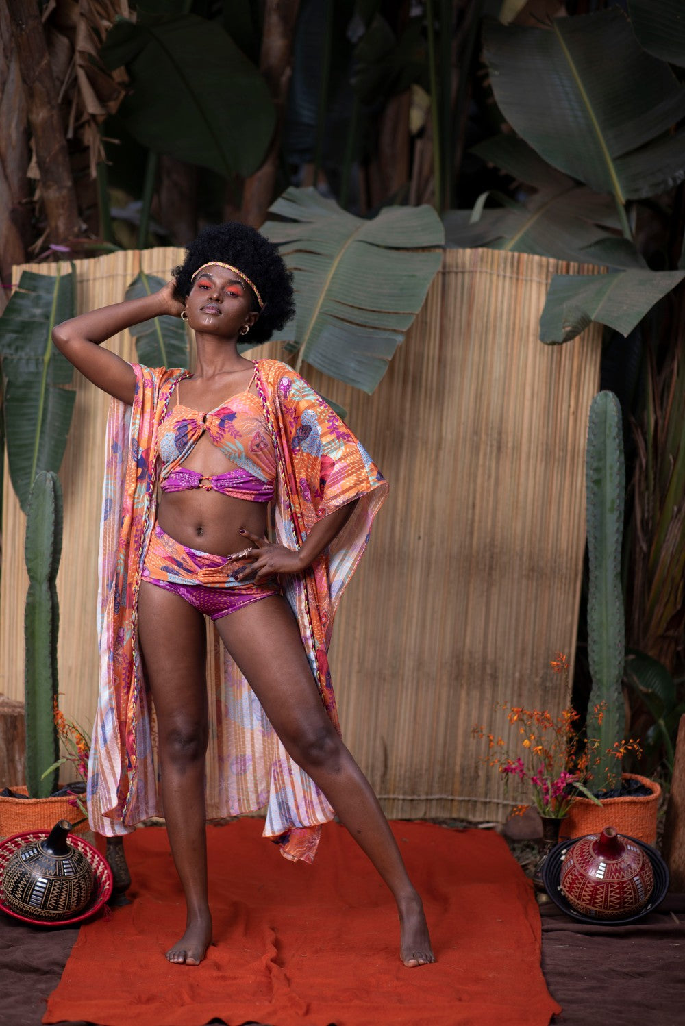 ORANGE AND PURPLE SWIMSUIT WITH AN ORANGE CAPE