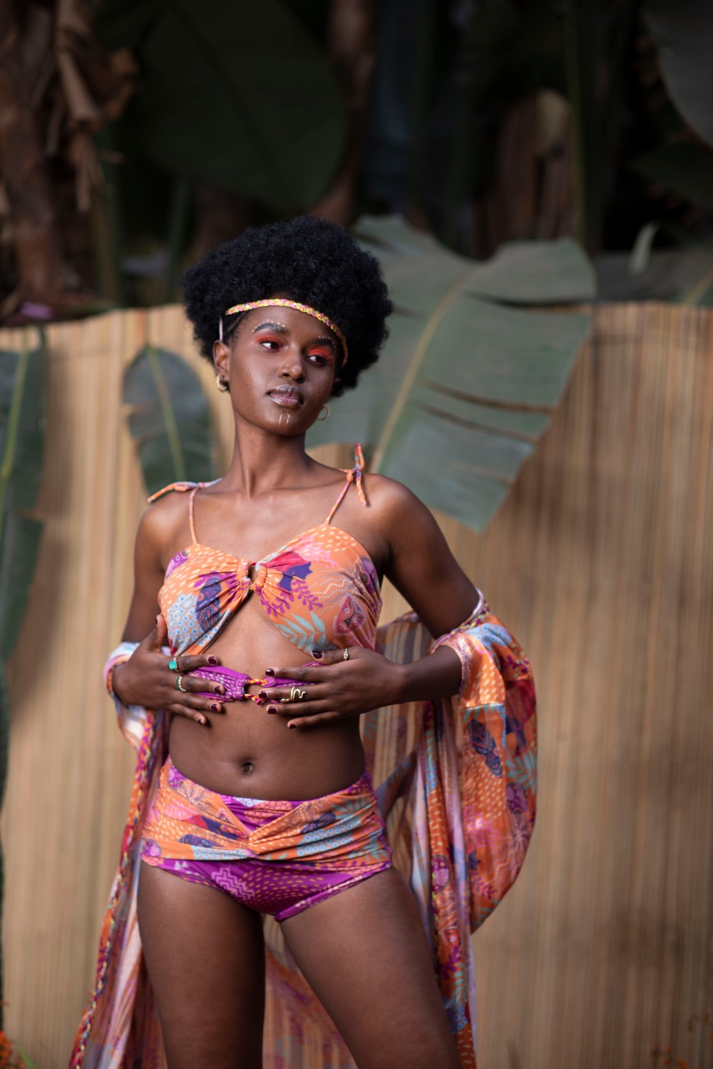 ORANGE AND PURPLE SWIMSUIT WITH AN ORANGE CAPE